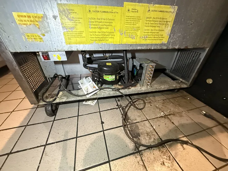 Back of the commercial prep cooler with the compressor