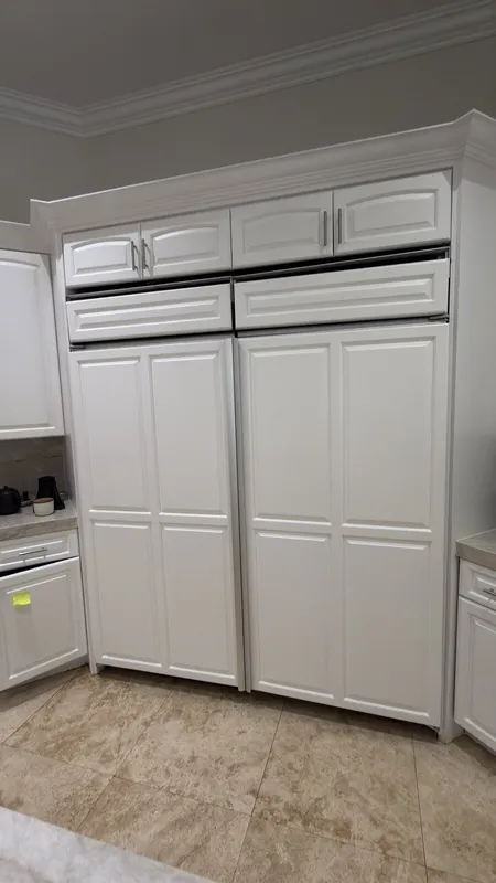 GE Monogram built-in refrigerator with white cabinet panels