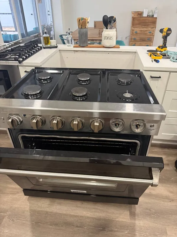 Kostch gas range in a Bonita Springs kitchen with two control knobs off