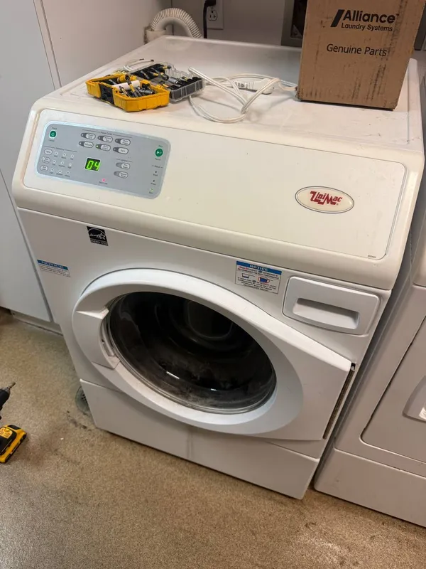 Commercial washer with tools and a parts box on top